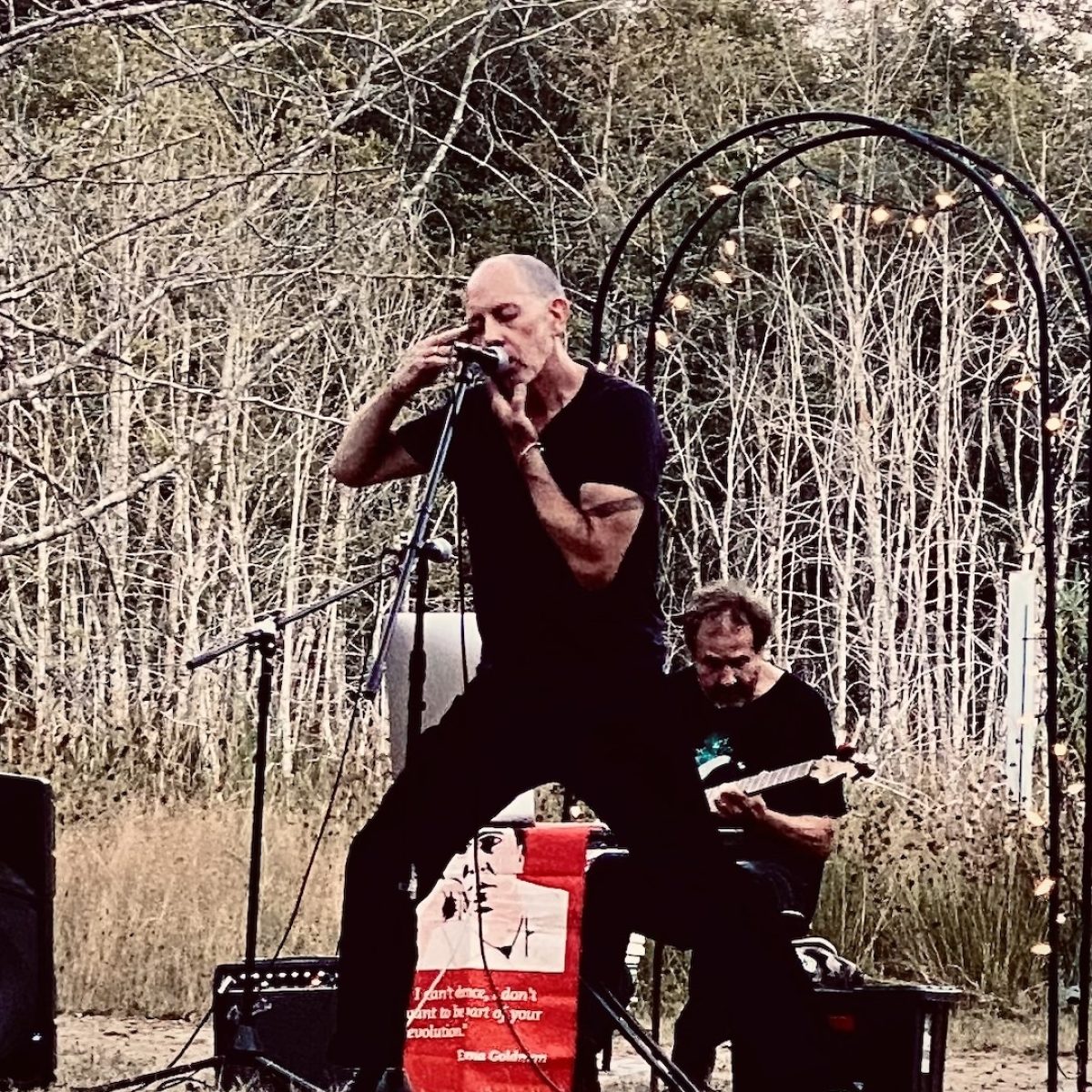 vocalist and guitarist perform outdoors