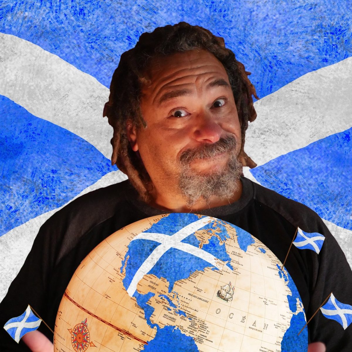Man with a beard holds a globe with scottish flags on it